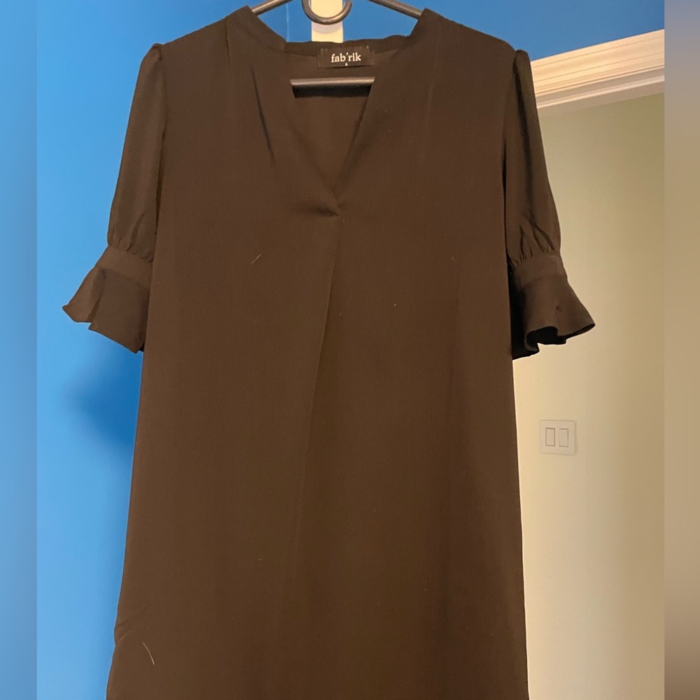 A mid sleeve length black mini dress.